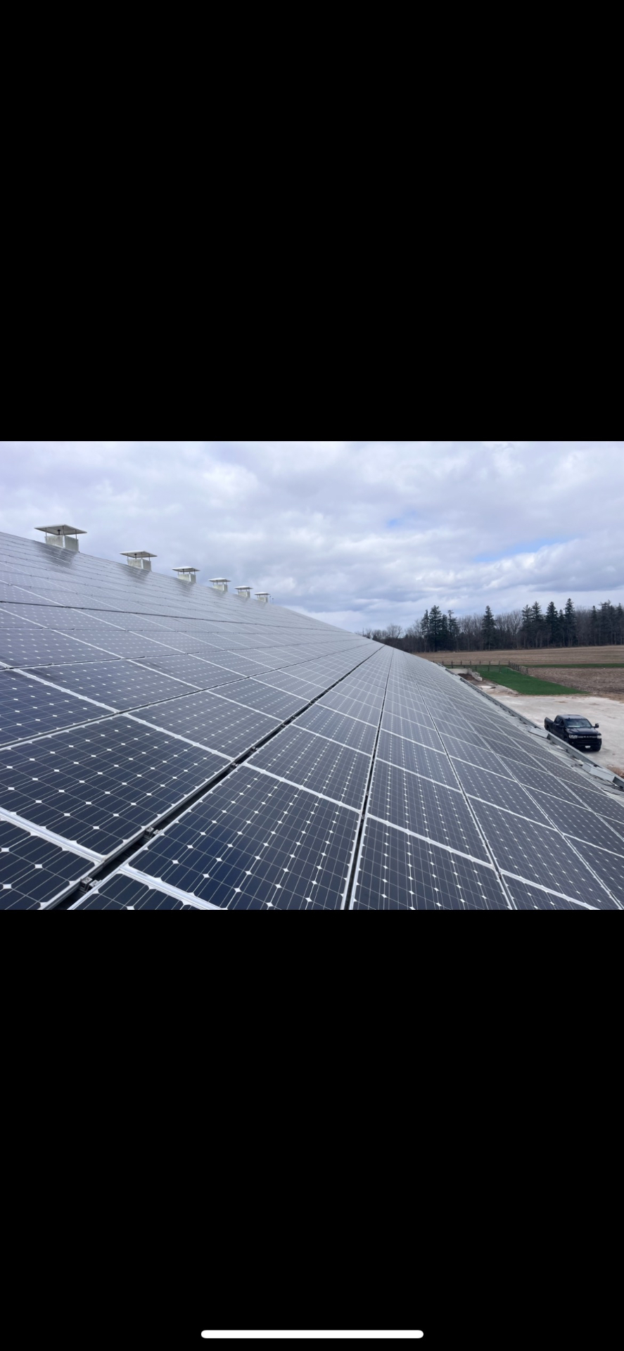 A rooftop solar installation in Ontario with farmland stretching to the horizon, prior to decommissioning.